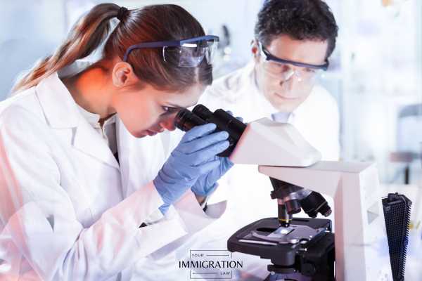a woman with eb-2 waiver status working in a lab 