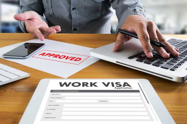 an approved permanent work visa form on a mans desk