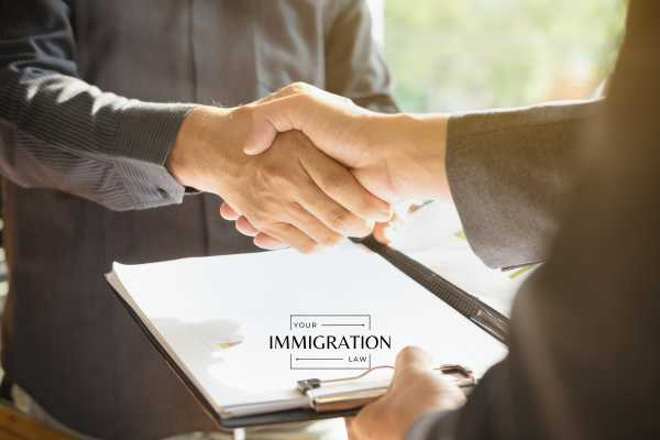 a man on an e-1 visa conducting a business deal