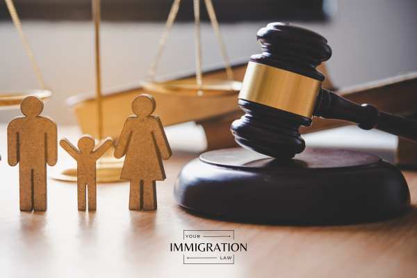 model figures of a family and a gavel on an immigration attorneys desk