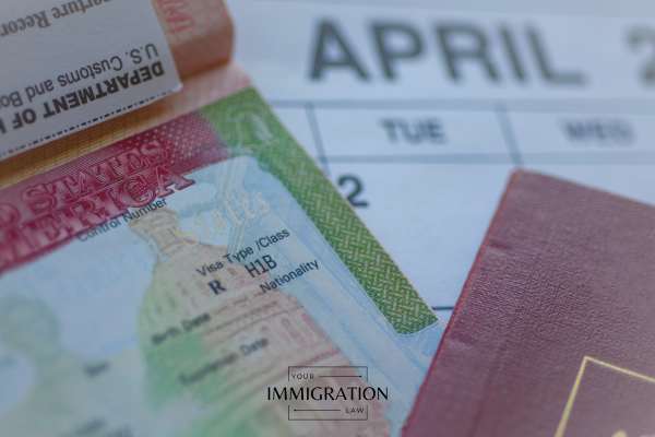 an h1b visa and a passport on a calendar