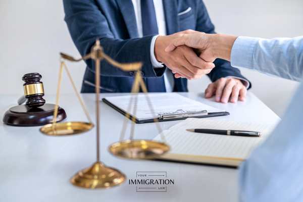 a man discussing an o-1 visa application with an attorney