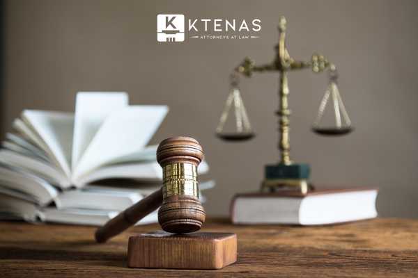 a gavel, scales of justice, and a law book on a desk