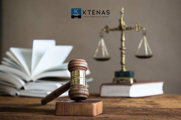 law books, a gavel, & scale of justice on an attorney desk