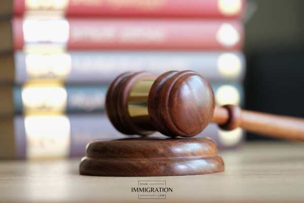 a gavel on a desk with legal books