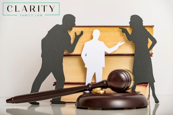 paper cut outs of parents arguing with a lawyer in between