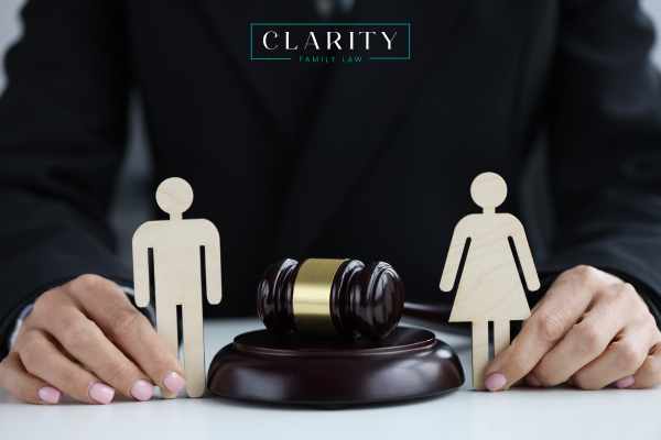 a woman at a desk with a cutout of a married couple separated by a gavel