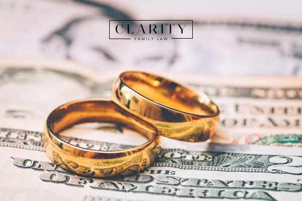 wedding rings and money on a desk