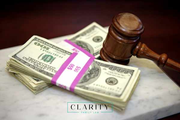 a gavel and two bands of money on a desk
