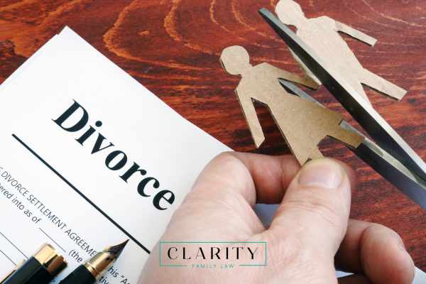 divorce forms and a cutout of a husband and wife on a desk