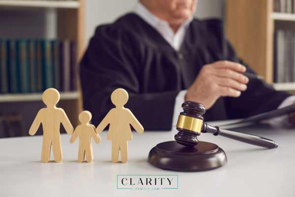 a judge reviewing a custody dispute case at a desk with a cutout of a family in the foreground