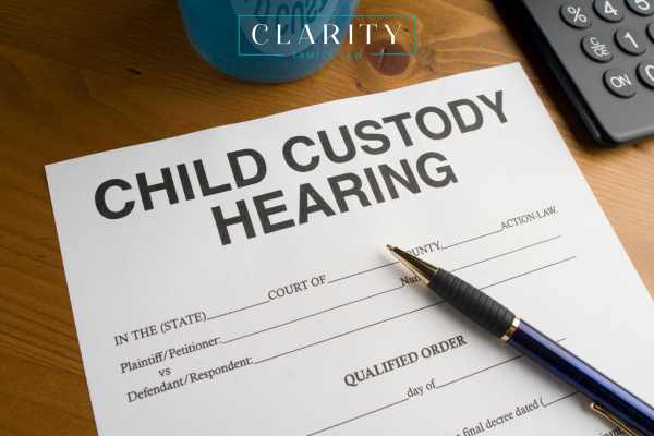 a custody hearing form and a pen on a desk