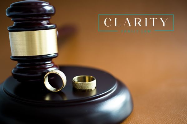 a gavel with two wedding rings on it
