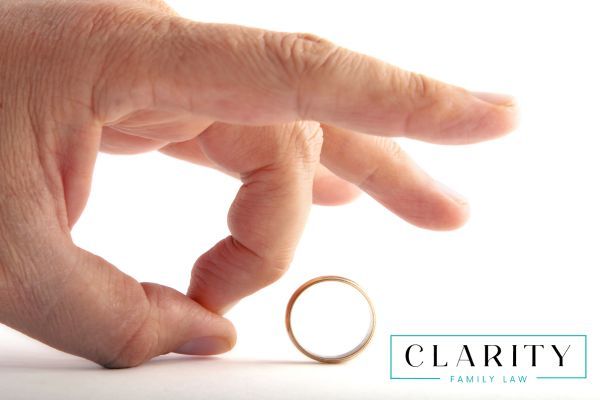 a person flicking their wedding band after a divorce