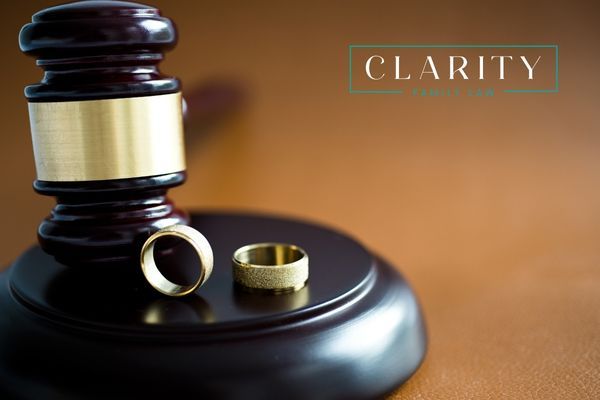 two wedding rings sitting next to a gavel
