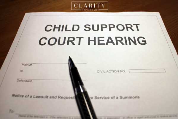 a child support hearing form and a pen on a desk