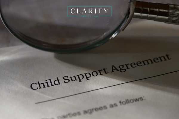 a magnifying glass and child support agreement