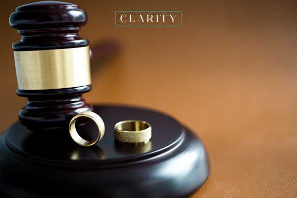 a gavel and wedding rings on a desk
