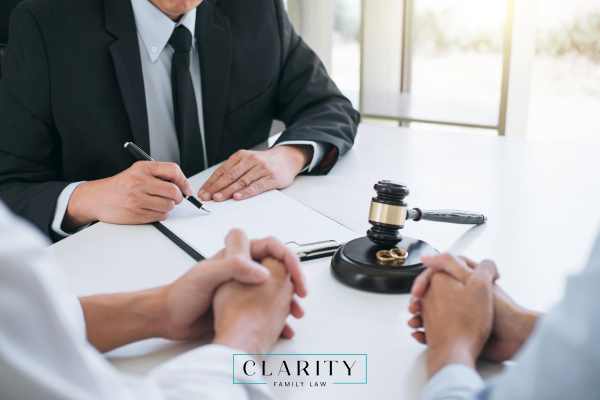 a couple negotiating a divorce with an attorney
