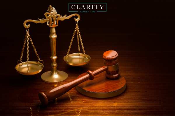a gavel and scales of justice on a wooden table