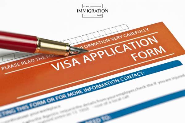 a blank visa application and pen on a desk