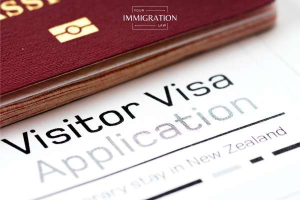 a b2 visa application and a passport on a desk