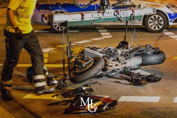 a motorcycle lying on its side in a road after an accident
