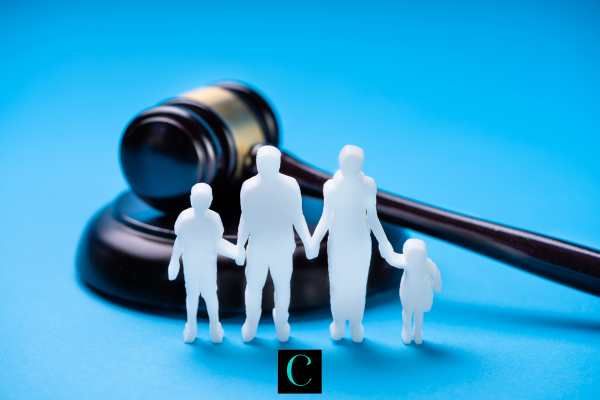 a cutout of a family in front of a gavel