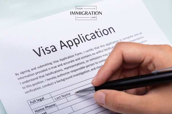 a person filling out an application for a visa