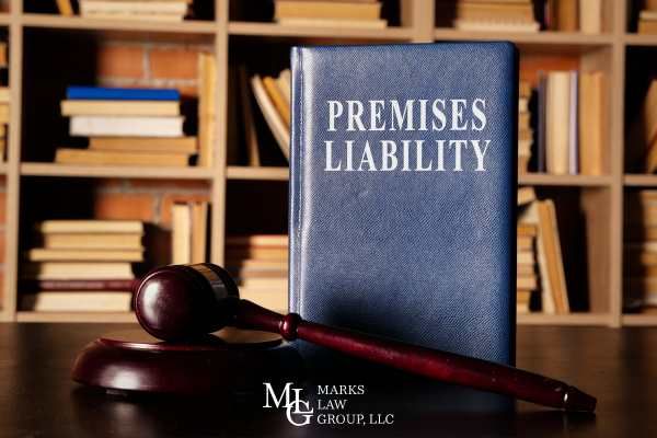 an attorneys desk with a gavel and legal book about premises liability on it