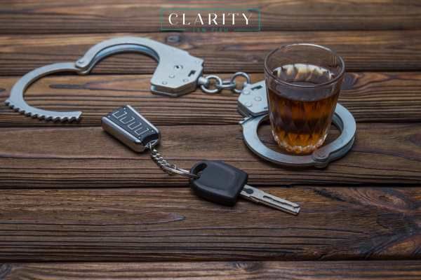 handcuffs, keys, and alcohol on a table
