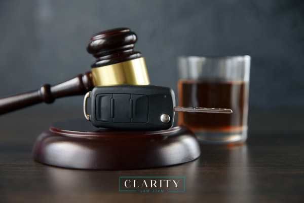 whiskey, a gavel, and car key on a table