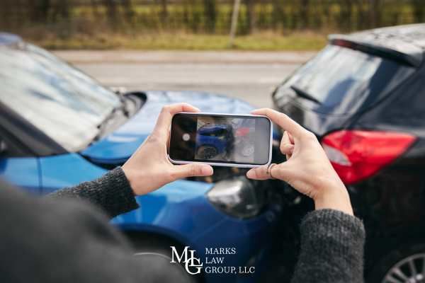 a man taking pictures of a car accident he was involved in