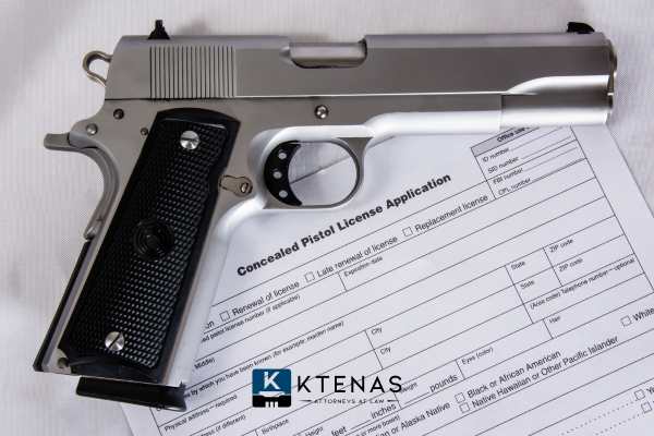 a handgun and CCW application on a desk