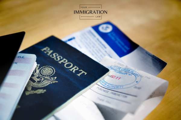 an immigration visa and passport on a desk
