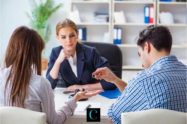 a couple discussing a divorce agreement with a mediator