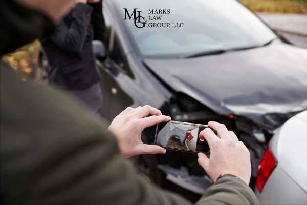 a man taking a photograph of a car accident