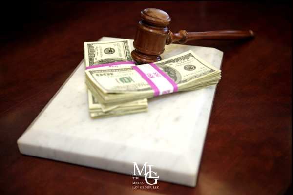 money and a gavel on an attorneys desk