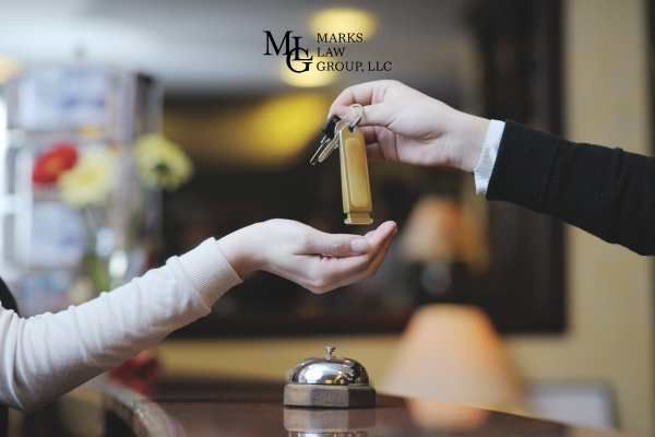 a woman getting a room key at a hotel