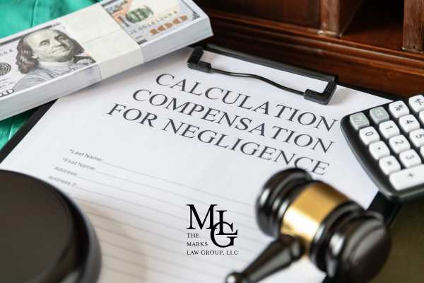 an injury claim form for negligence and money on a desk