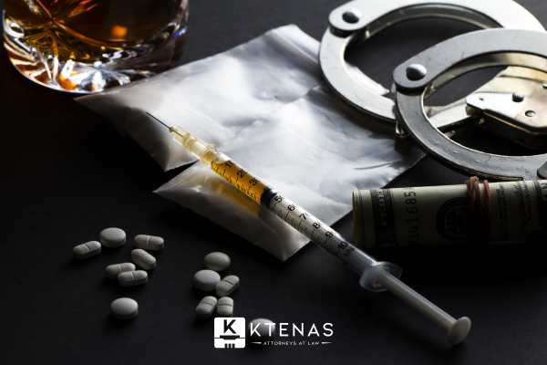 drugs and handcuffs on a black table