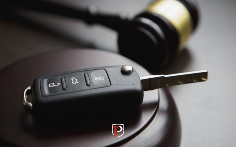 keys and a gavel on a wooden table