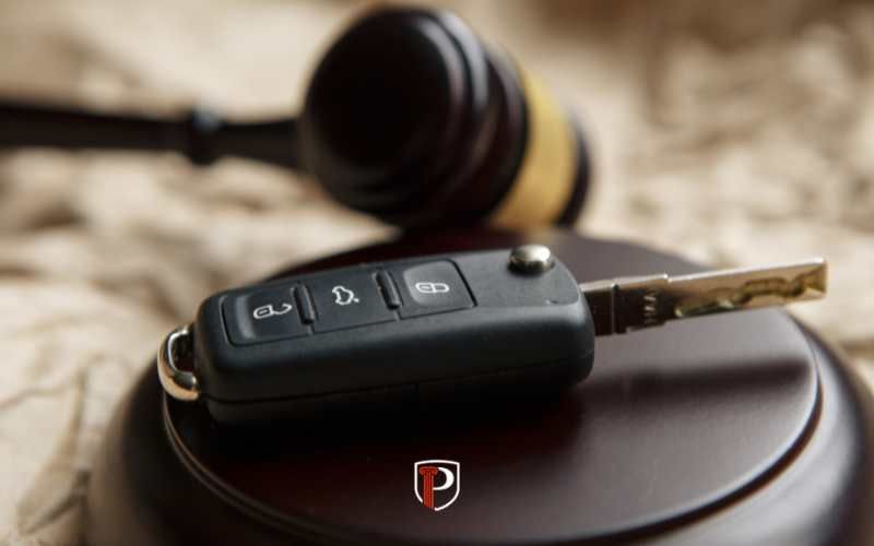 car keys and a gavel on a desk