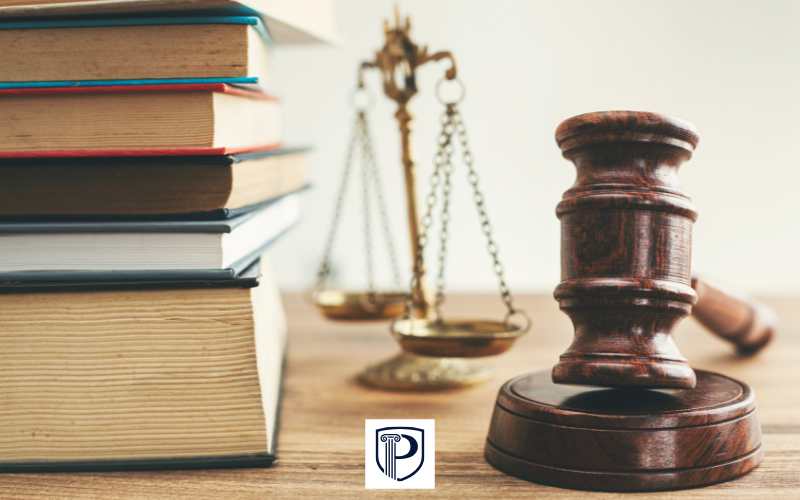 a desk in a law firm with law books and a gavel on it