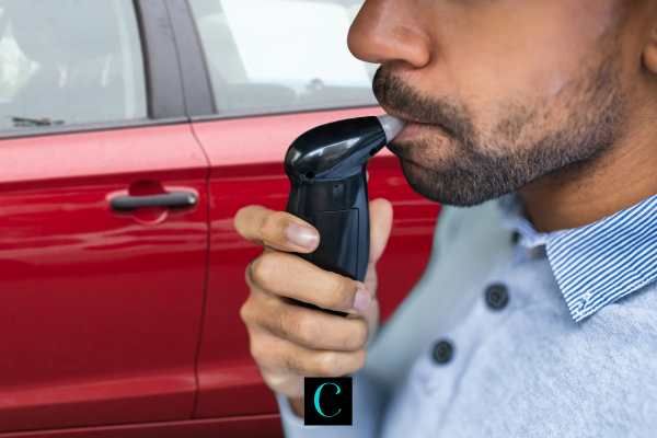 a man taking a breathalyzer test