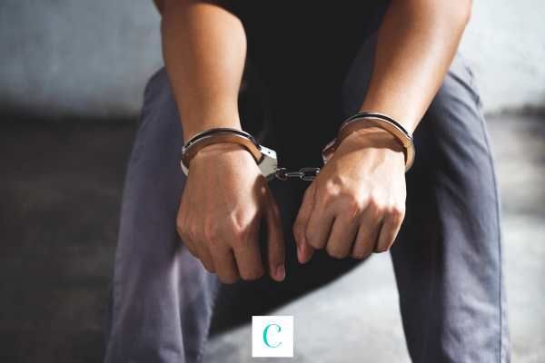 a man handcuffed for domestic violence