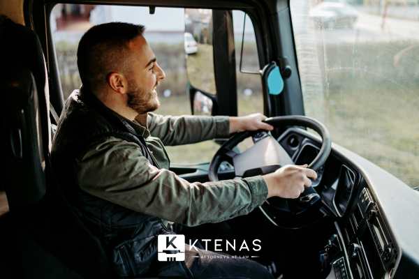 a man driving a commercial truck on a highway