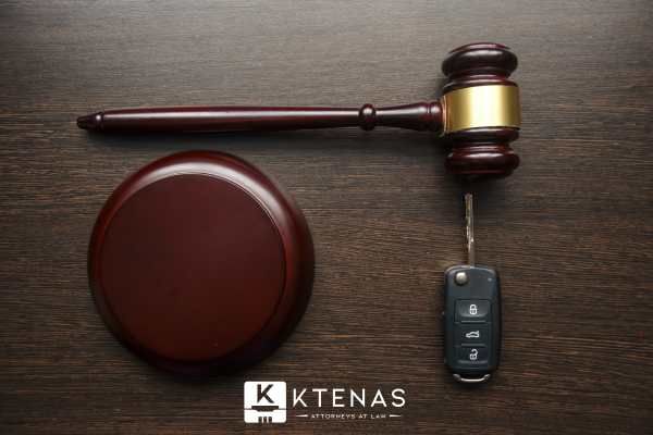 a gavel and car keys on a desk