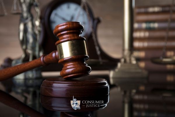 a desk at a law firm with legal books and a gavel on it