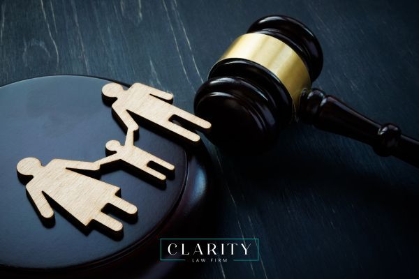 a closeup photo of a gavel and cutout of a family on a black table